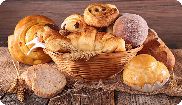 Assorted pastries in a wicker basket display.