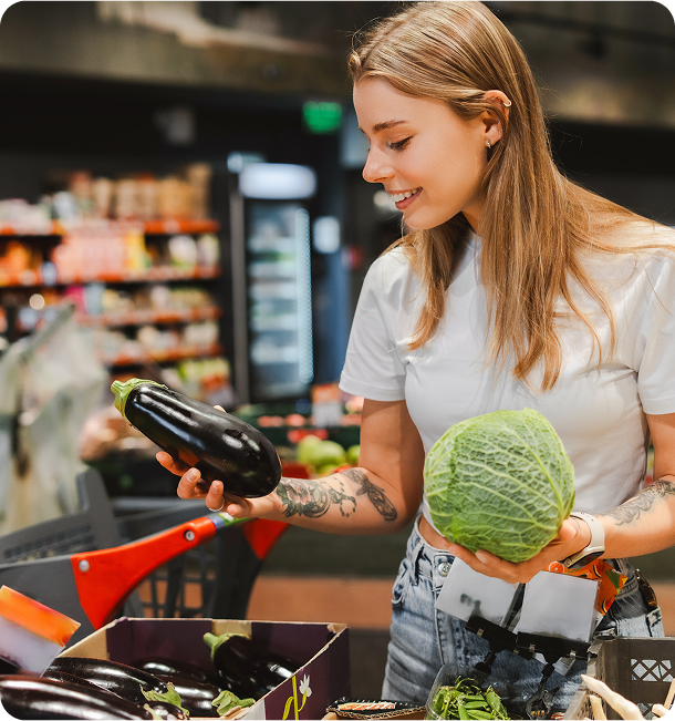 Woman shopping for vegetables in grocery store.